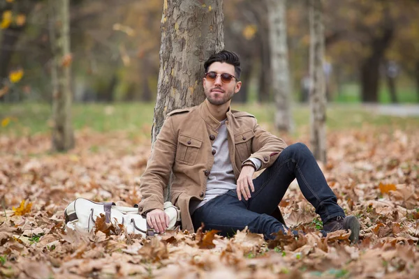 Young adult man handsome posing in the wood, winter autumn day