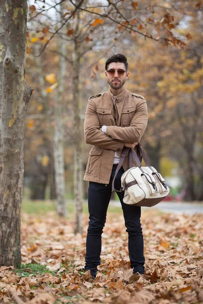 Young adult man handsome posing in the wood, winter autumn day