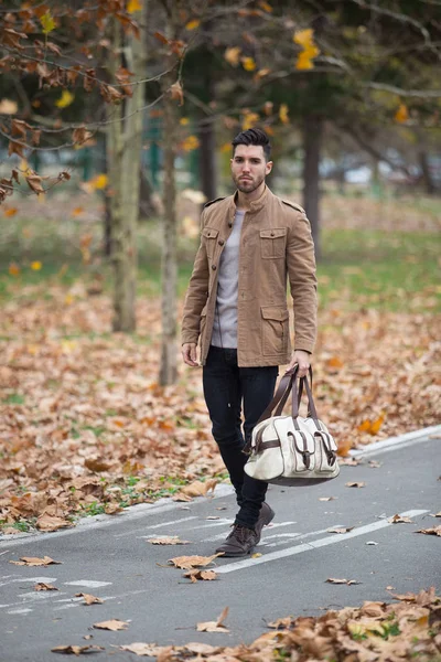 Young adult man handsome walking in the wood, winter autumn day