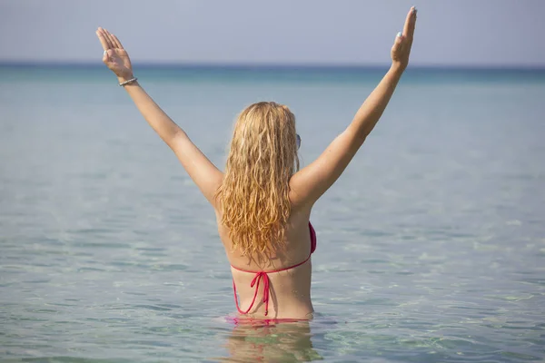 Young woman with beautiful blonde hair meditating in sea — Stock Photo, Image
