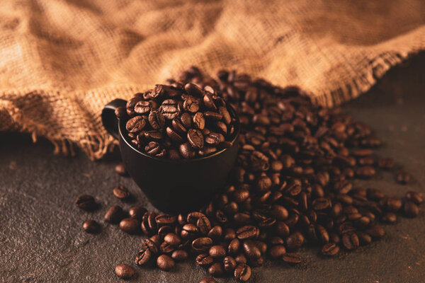 Coffee beans. Coffee cup full of coffee beans. Toned image