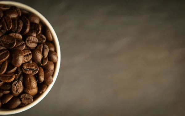 Coffee beans. Coffee cup full of coffee beans. Toned image — Stock Photo, Image