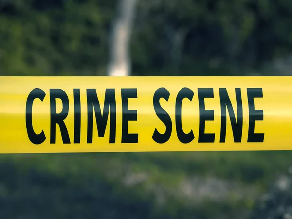 Crime scene tape closeup, police tape Do Not Cross outdoors