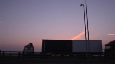 Kargo konteynırı kamyonu şafakta köprüde olacak.