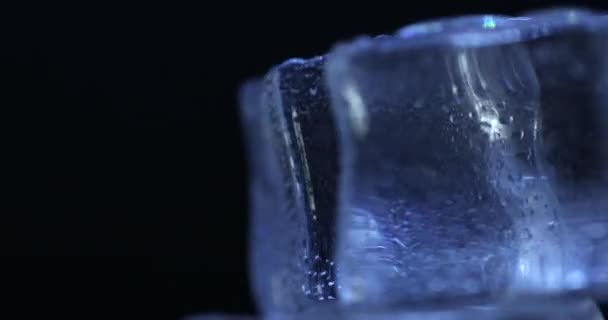 Ästhetische Eiswürfel Nahaufnahme auf schwarzem Hintergrund, Drehung — Stockvideo
