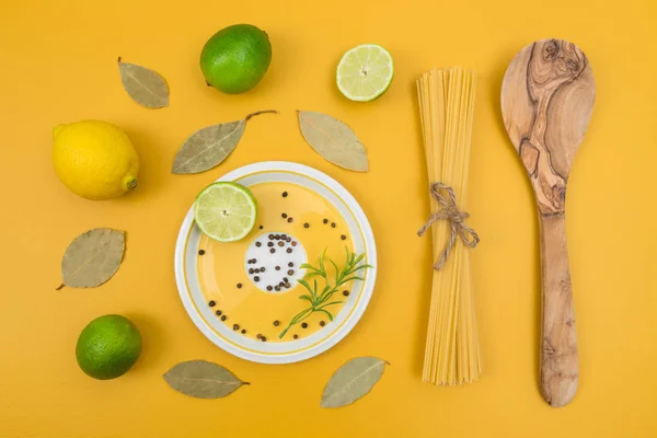 Cooking Ingredients Bright Yellow Background Limes Lemons Laurel Leaves Pasta — Stock Photo, Image