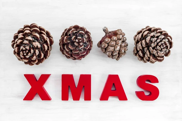 Christmas Theme Pine Tree Cones Word Xmas Written Red Letters — Stock Photo, Image