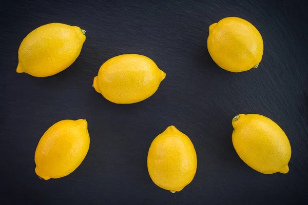 暗いスレート背景上の新鮮なレモン 熟した柑橘系の果物 — ストック写真