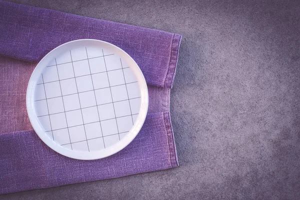 Checked White Plate Purple Tablecloth Dark Concrete Background Copy Space — Stock Photo, Image