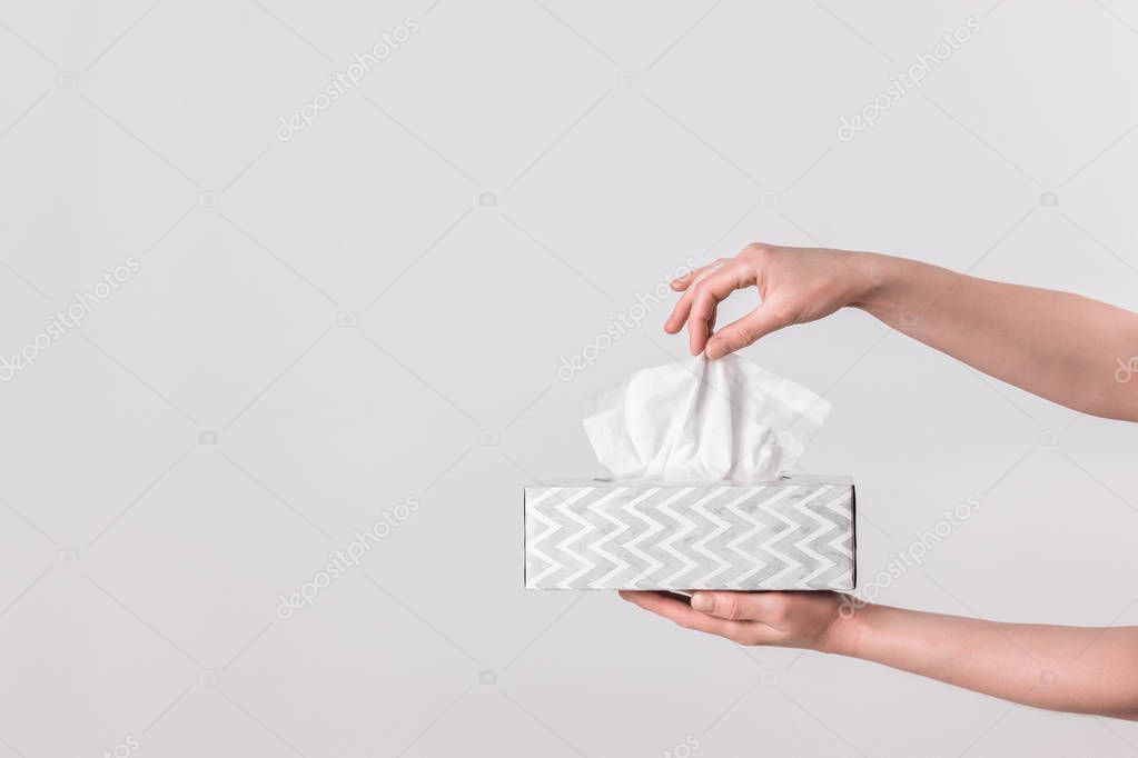 Delicate female hands holding a tissue box — Stock Photo