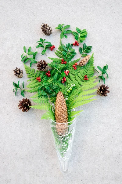 Glass cone with wild forest plants and berries — Stock Photo, Image