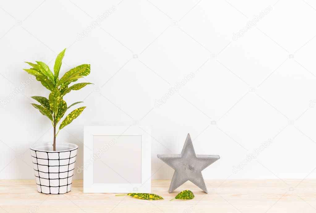 Home decor with picture frame, concrete star and plant
