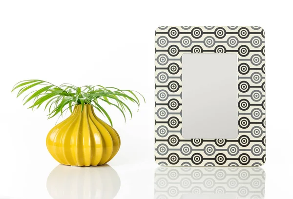 Vase with palm leaves and retro style picture frame — Stock Photo, Image