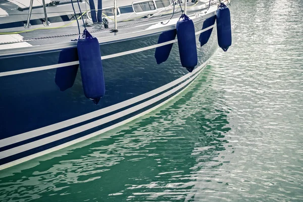 Blue motorboat reflecting in water — Stock Photo, Image