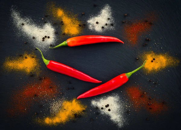 Hot pepper seasoning on dark background — Stock Photo, Image