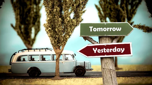 Street Sign to Tomorrow vsus Yesterday — стоковое фото