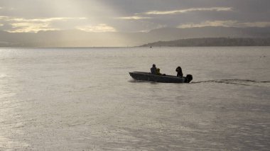 Yağmurlu bir günde fiyortta bir teknenin arka ışığı.