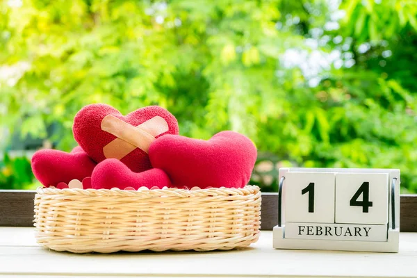 Red felt heart with adhesive plasters on basket