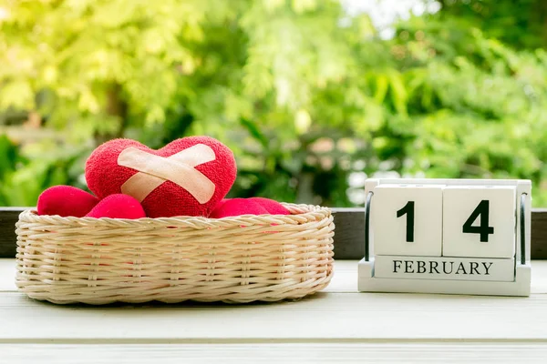 Red felt heart with adhesive plasters on basket