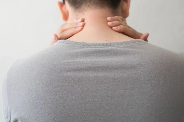 Photograph of a man from the back with pain and neck injury