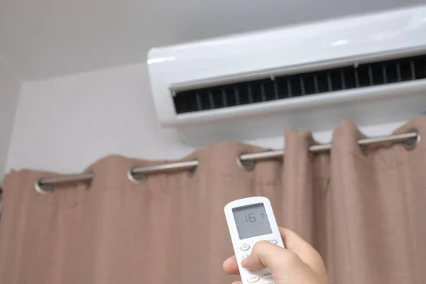 Focus ahead.Air condition control by using remote control and tu — Stock Photo, Image