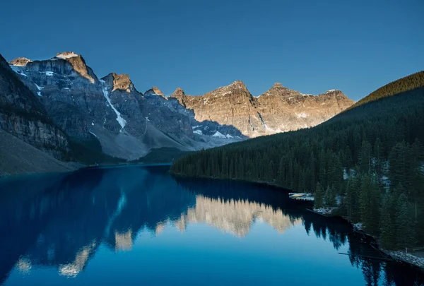 Sun rising view a top of a peak overlooking Lake Moraine in Banff National Park.