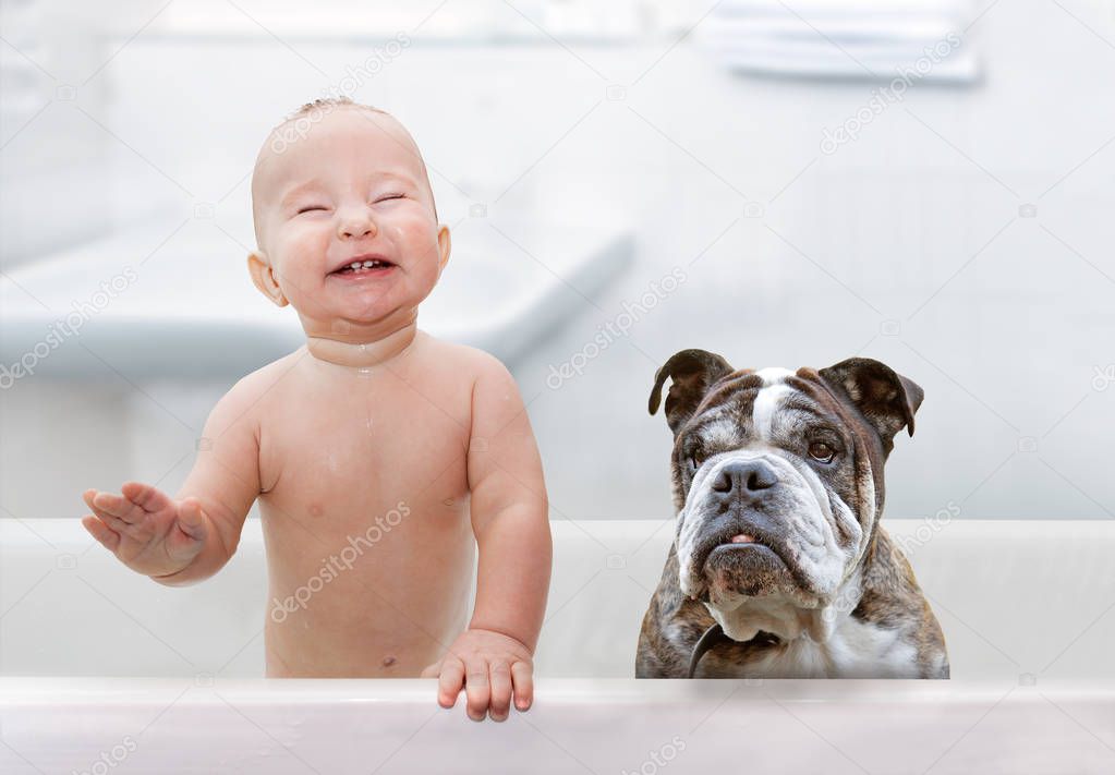 laughing baby and dog in white bathtub