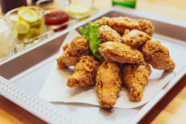 Golden Crunchy Korean Fried Chicken (basic Huraideu-Chikin) served with pickled and Soju. In South Korea, fried chicken is consumed as a meal, an appetizer, Anju, or as an after-meal snack.
