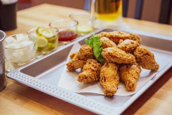 Golden Crunchy Korean Fried Chicken (basic Huraideu-Chikin) served with pickled and cold beer. In South Korea, fried chicken is consumed as a meal, an appetizer, Anju, or as an after-meal snack.