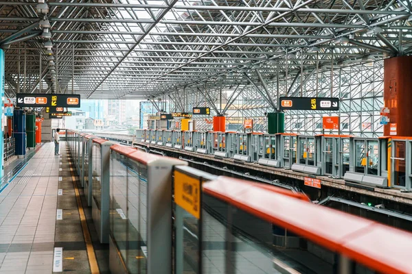 The Taipei Beitou Metro Station with people waiting on the platform for a train. Public transportation. Contemporary architecture and culture with modern design.