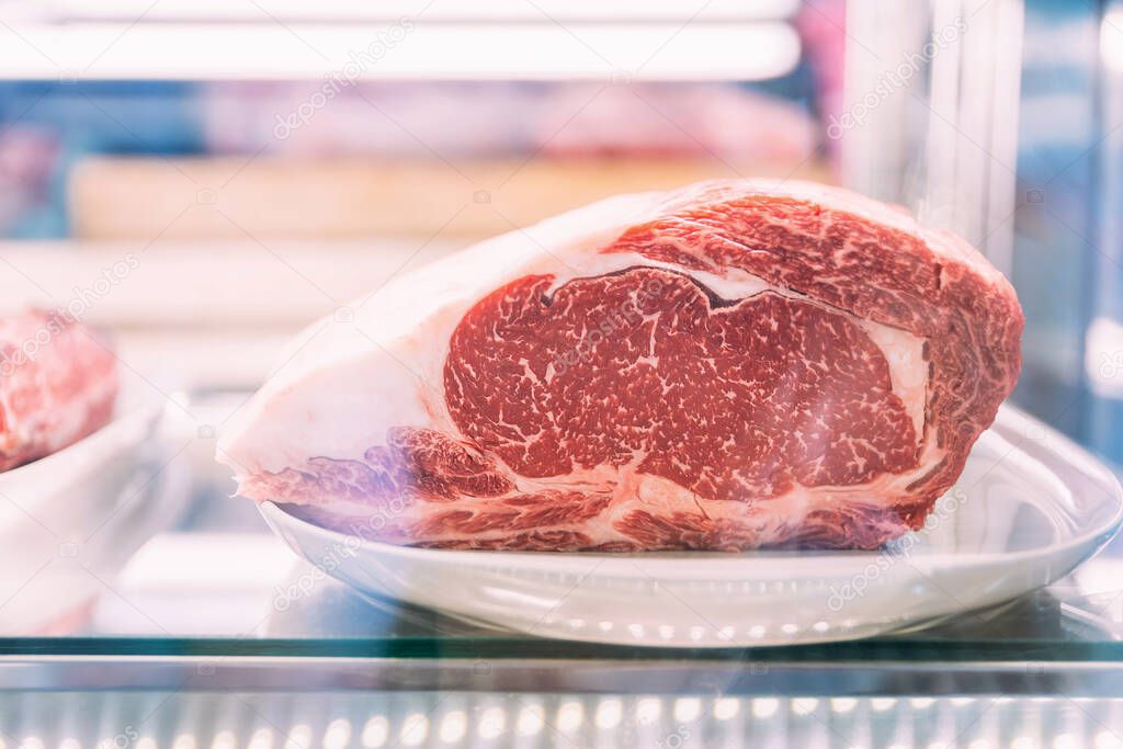 Premium Rare Sirloin Dry-Aged  Wagyu A5 beef with high-marbled texture inside refrigerator.