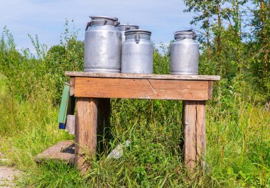 Garaj yolundaki süt masası ve alüminyum camlar. Letonya'da yaz aylarında Latgale
