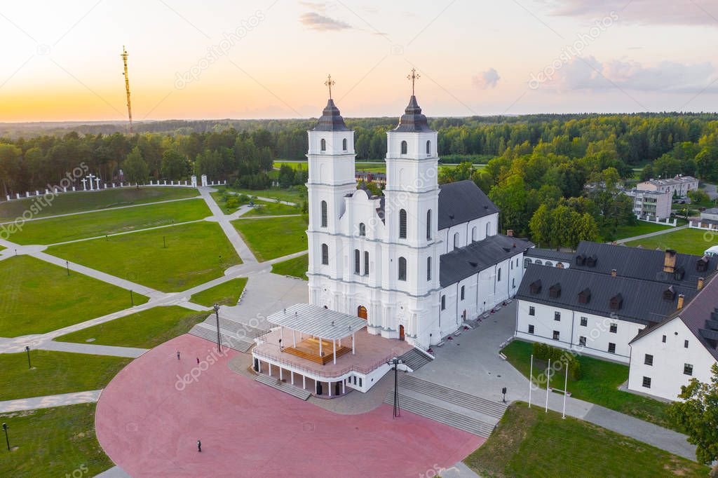 Beautiful Aerial view from drone on white Chatolic Church basilica in Latvia ,Aglona, nice blue sky and white clouds In the evening at sunset