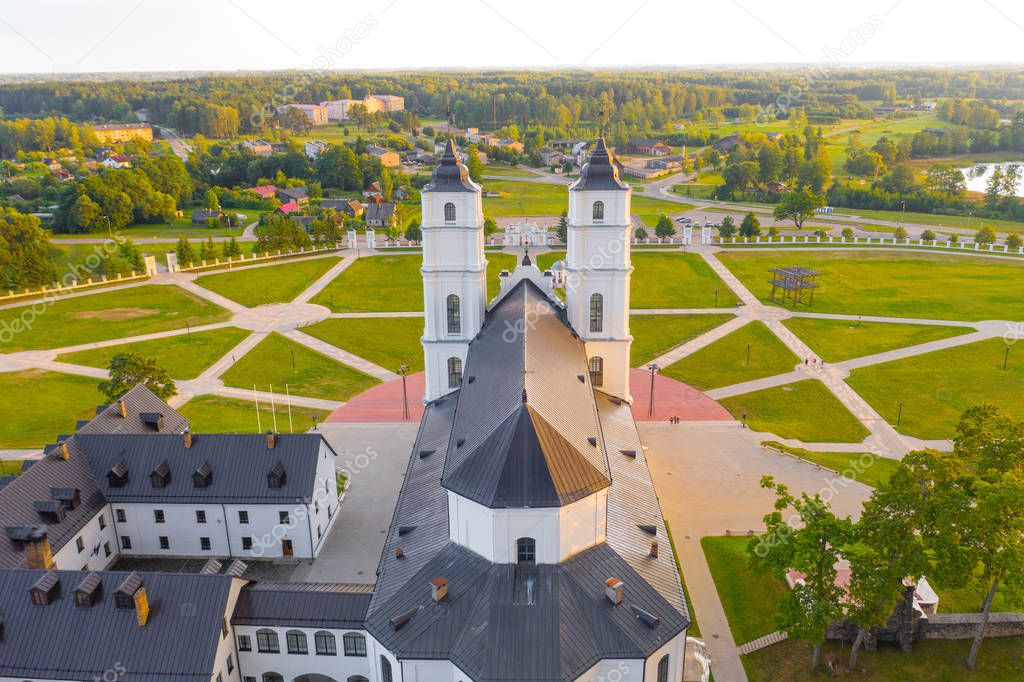 Beautiful Aerial view from drone on white Chatolic Church basilica in Latvia ,Aglona, nice blue sky and white clouds In the evening at sunset