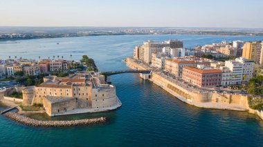 Beautiful panoramic aerial view photo from flying drone on Old medieval Aragonese Castle on sea channel, old town of Taranto city, Puglia (Apulia), Italy (Series) clipart