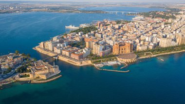 Beautiful panoramic aerial view photo from flying drone on Old medieval Aragonese Castle on sea channel, old town of Taranto city, Puglia (Apulia), Italy (Series) clipart