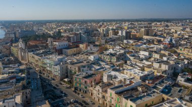 Molfetta rıhtımından ve eski kasabadan gelen güzel panoramik hava manzaralı fotoğraf. Gemileri ve yatları olan liman, Molfetta 'nın güneş doğarken yeni şehrini kapsıyor.)