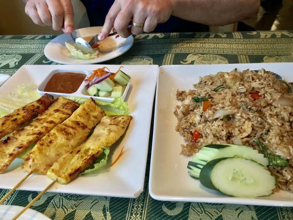 男が皿の上で食べ物を切っている チャーハン — ストック写真