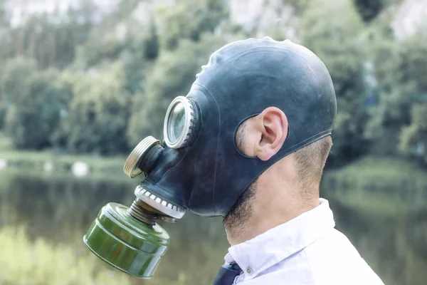 A man on outdoor in a gas mask. Bad ecology Air pollution, toxic emissions. Danger to life