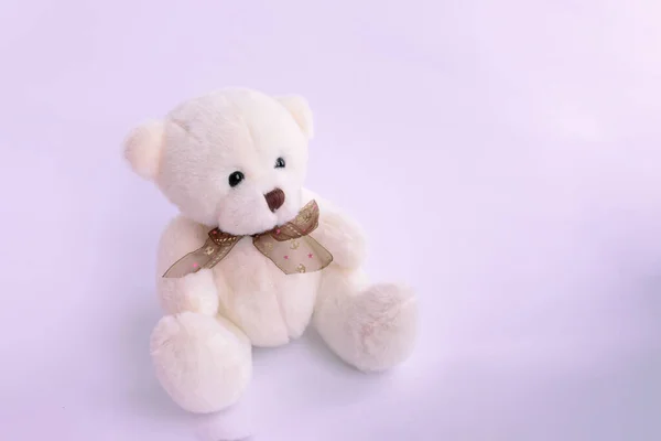 plushie Teddy bear sitting with light pink background