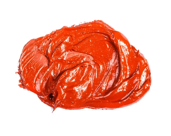 Mancha de tinta a óleo vermelho-laranja sobre um fundo branco . — Fotografia de Stock