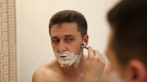 Young Caucasian Man Shaving His Face Safety Razor Reflection Mirror — Stock Video