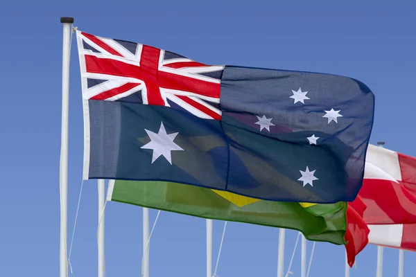 The Australian Flag Fluttering at the Front of a row of International Flags
