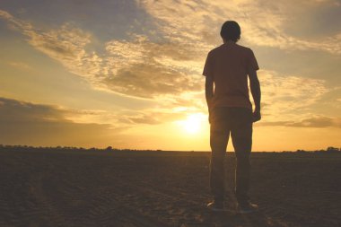 Adam ve günbatımı. Adam alanında.