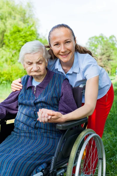 Handicapped Elderly Woman Sitting Wheelchair Smiling Caretaker Outdoor — Stock Photo, Image