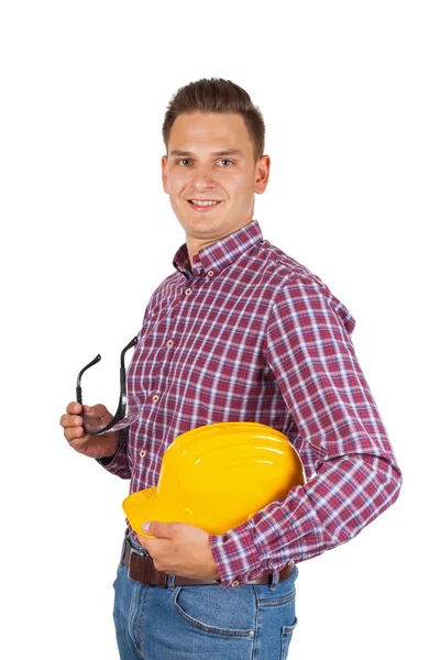 自信的年轻工程师持有黄色安全帽在孤立的背景下 — 图库照片