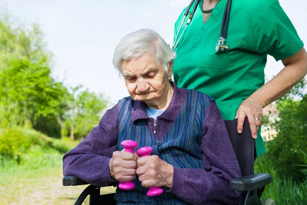 Handicapped Elderly Woman Sitting Wheelchair Smiling Caretaker Outdoor — Stock Photo, Image