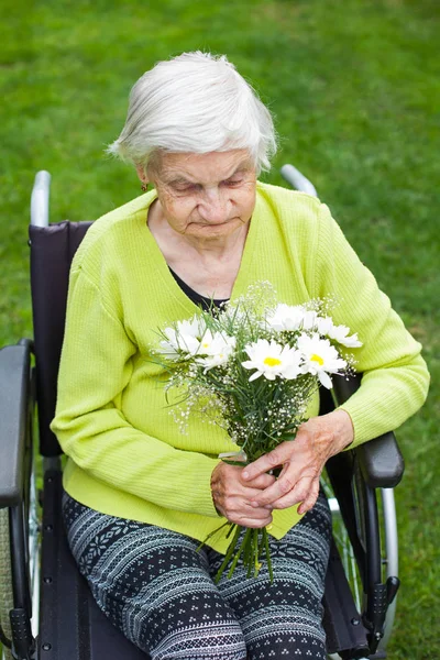 Wyłączona Starsza Kobieta Siedzi Wózku Inwalidzkim Odbiera Bukiet Kwiatów Urodziny — Zdjęcie stockowe