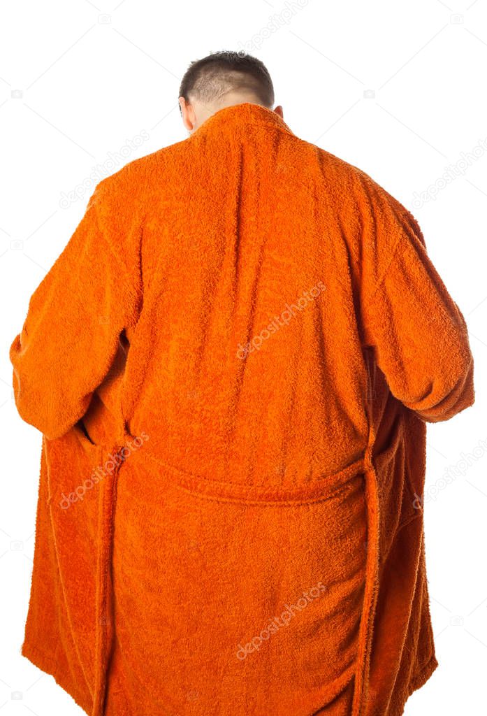 Young man  posing in bathrobe after shower, back view