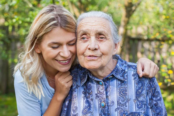 Young Attractive Woman Embracing Old Grandmother Outdoor Female Generations Love — Stock Photo, Image